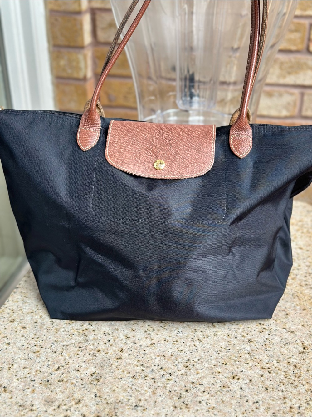 Longchamp Black Tote Bag, with Brown Trim-foldable. Long shoulder handles.